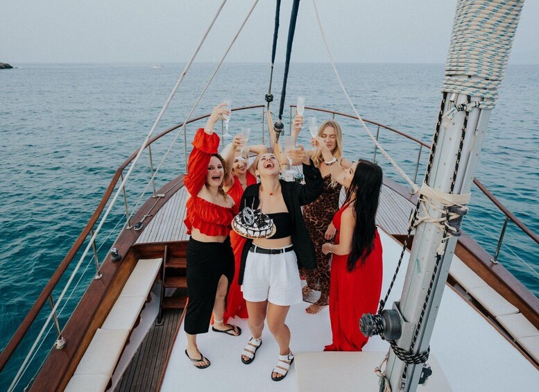 A group of people on a boat with the sea in the background. 1