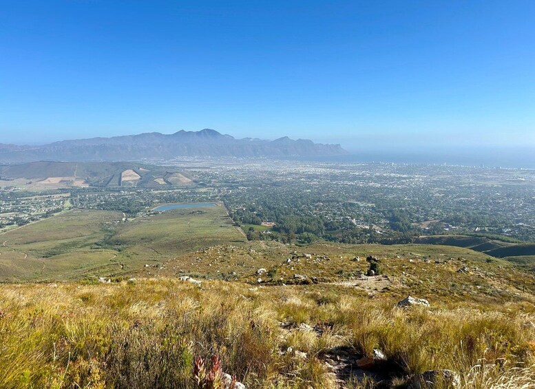 A mountainous landscape with a city in the valley below. 2