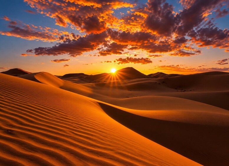 A desert landscape with sand dunes and a sunset. 2