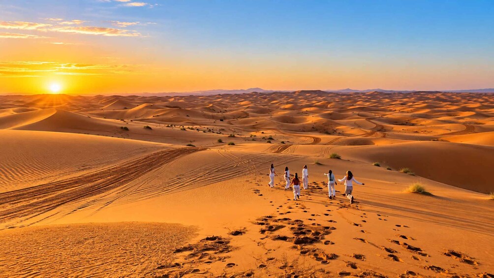 A desert landscape with sand dunes and a group of people walking. 1