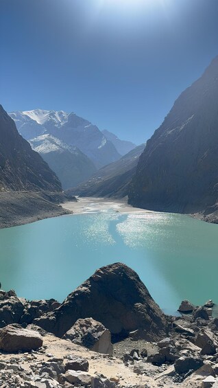 A mountain lake surrounded by rugged terrain and snow-capped peaks. 4
