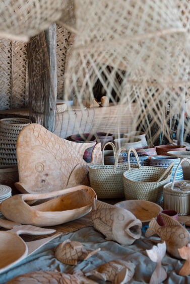 A variety of woven baskets and wooden items, including a fish-shaped bowl and a woven chair. 3
