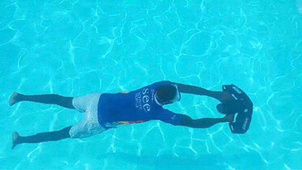 A person swimming in a pool. 4