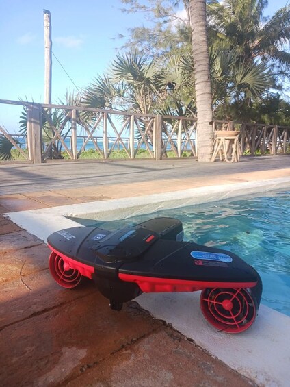 A poolside with a jet ski and palm trees. 1