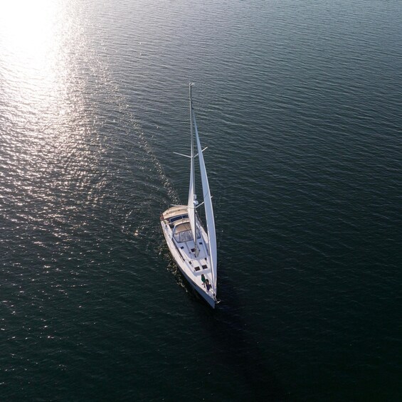 A sailboat on calm water with a clear sky. 2