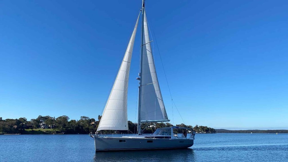 A sailboat on calm waters with a clear sky. 4
