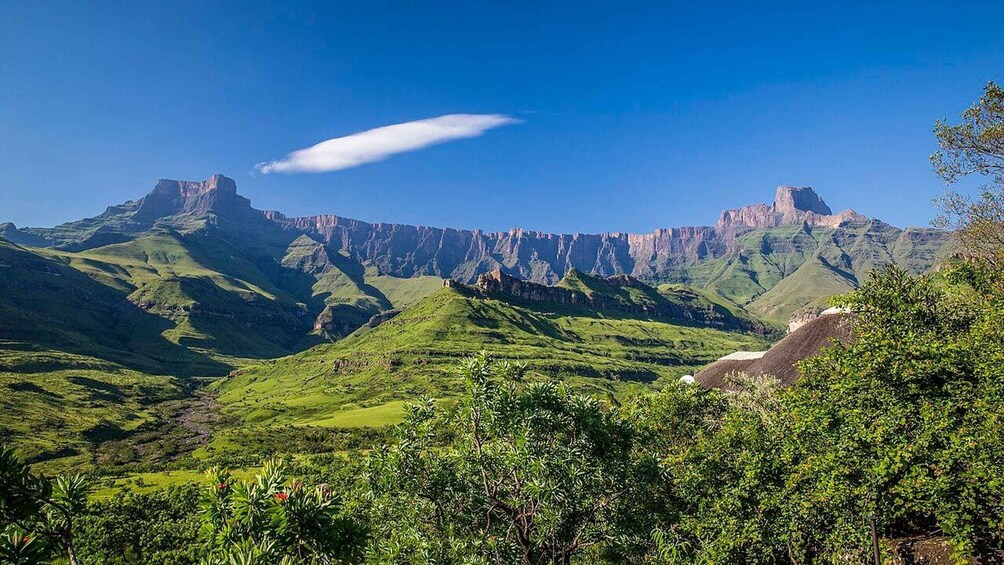 A mountainous landscape with lush greenery and rocky cliffs. 4