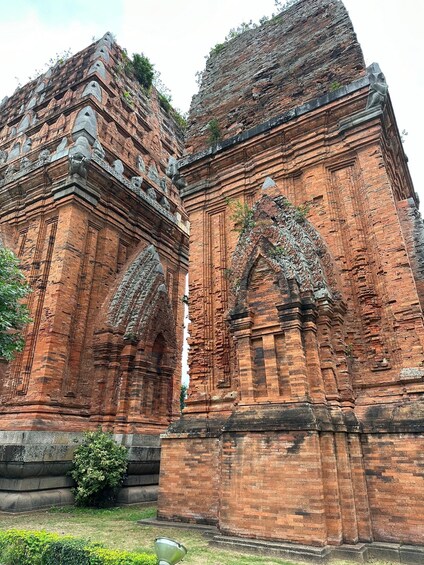 A large, ancient brick structure with intricate carvings and a large central doorway. 4