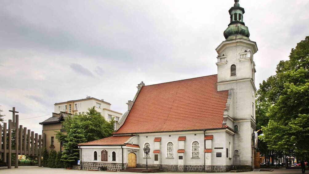 A church with a red-tiled roof and a bell tower. 3
