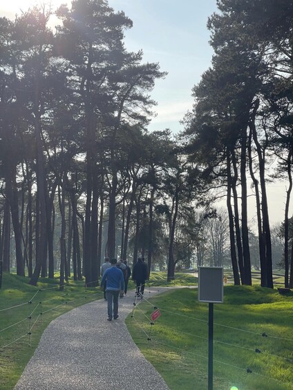 A gravel path in a forest with people walking. 2