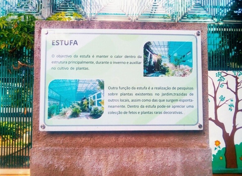 A signboard with information about a greenhouse, including its purpose and a photo of the structure. 4