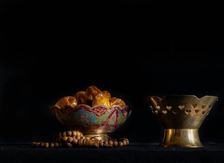 A bowl of sweets and nuts on a dark surface. 5