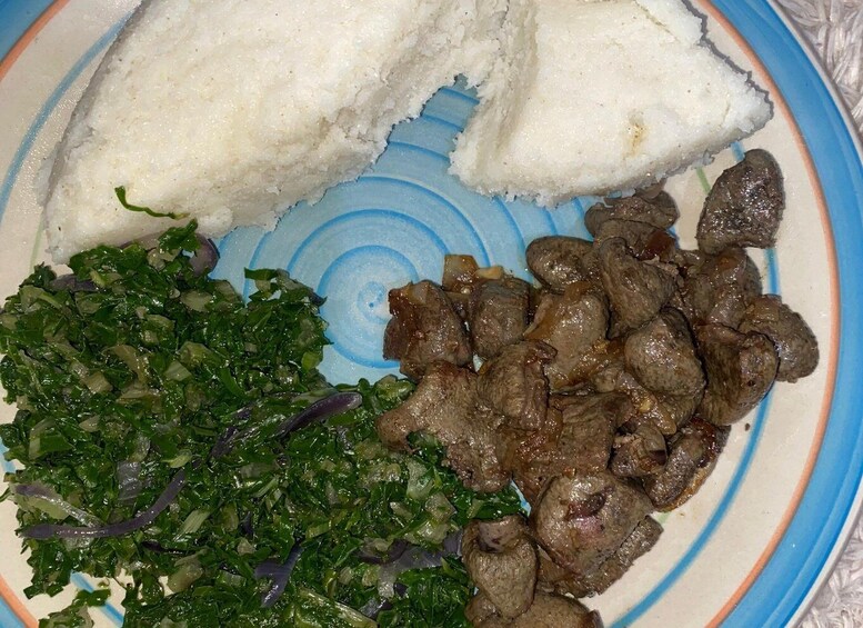 A plate with white rice, green leafy vegetables, and cooked meat. 3
