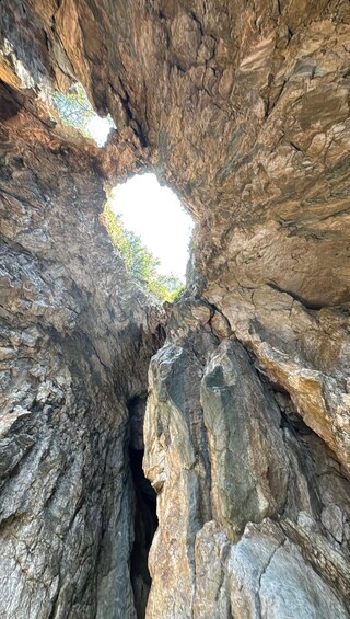 A rock formation with a natural archway and a small opening at the bottom. 2