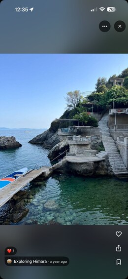 A coastal scene with clear water, a wooden dock, and stone stairs leading to a building. 4