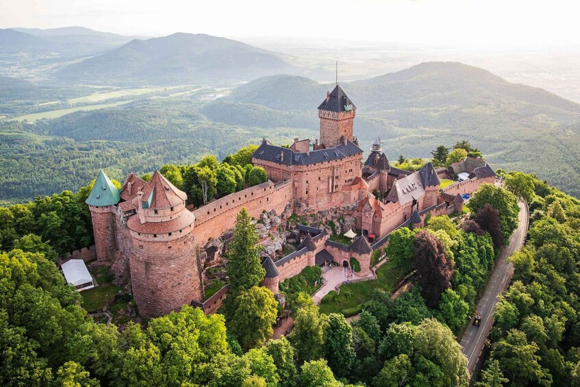 A historic castle surrounded by lush greenery and hills. 3