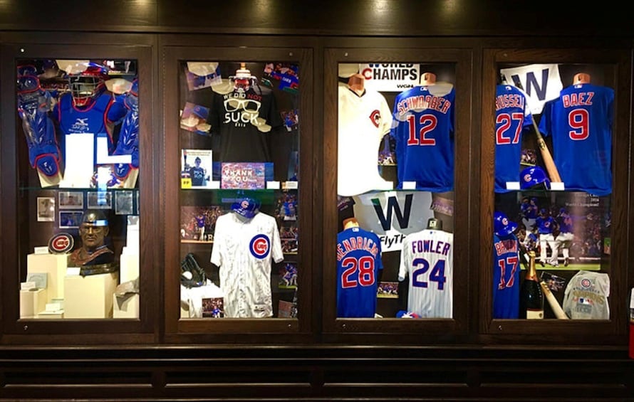 A display case with baseball jerseys and memorabilia. 2