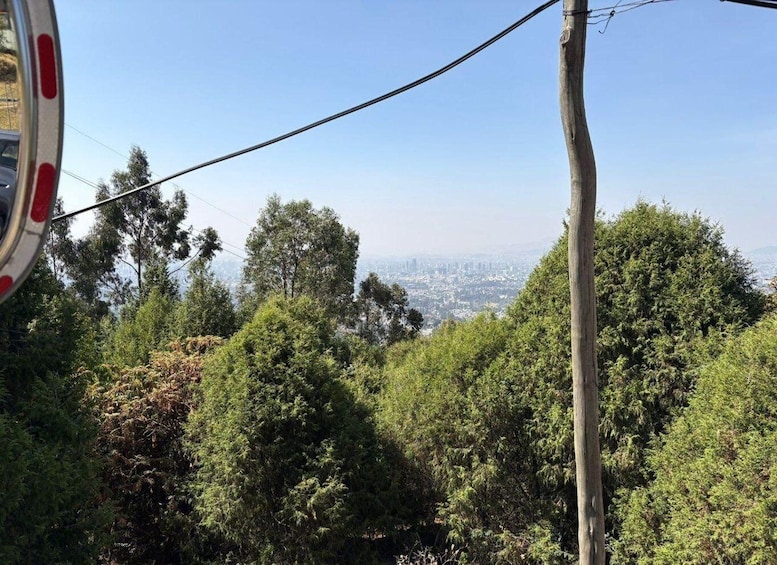 A cable car with a cityscape in the background. 1