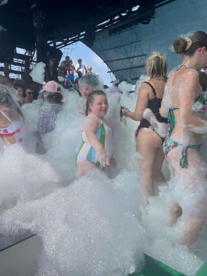 People in a water park with water slides and foam. 2