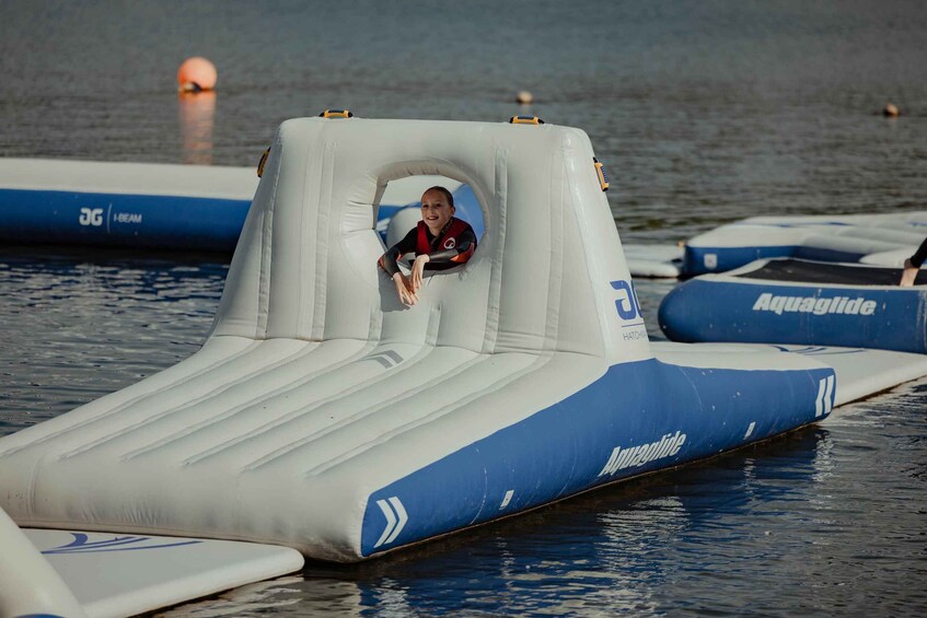 An inflatable water slide with a person at the top. 5