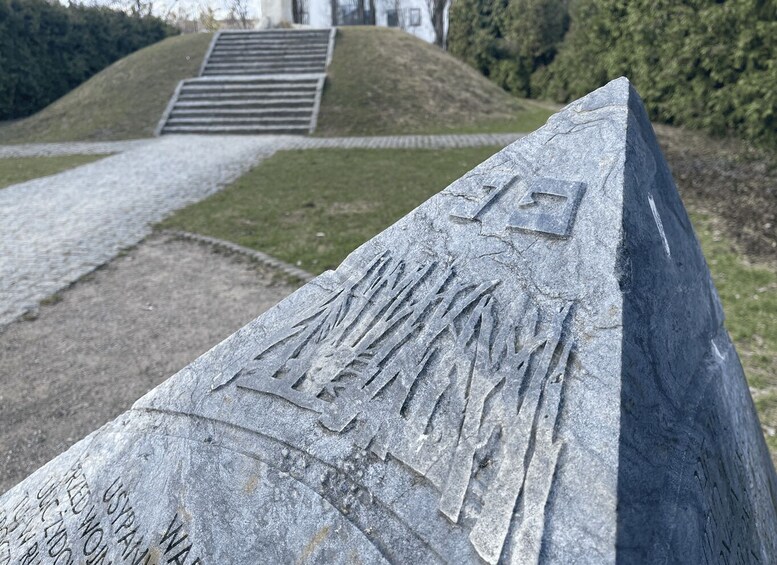 A stone monument with inscriptions and a triangular top. 3