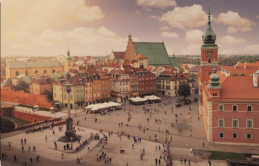 A historical square with buildings, a prominent tower, and a central monument. 5