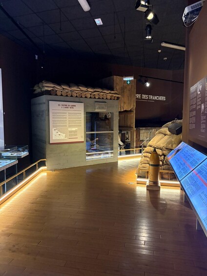 A museum exhibit with historical artifacts, including a display case and informational panels. 4