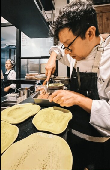 A chef preparing food in a kitchen. 5