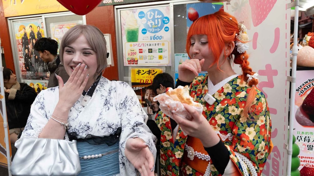 Two people eating in a busy indoor setting with Japanese signage. 2