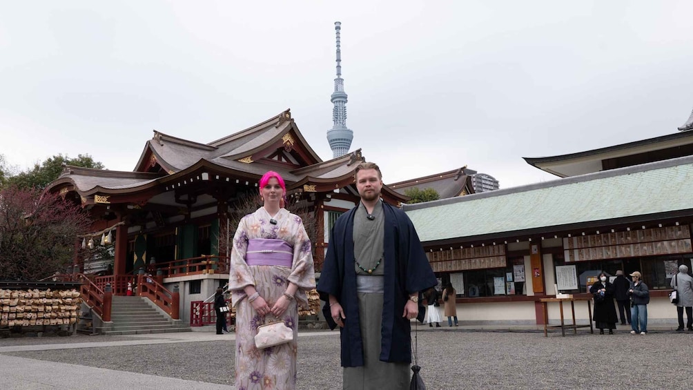 A traditional Japanese building with a modern tower in the background. 3