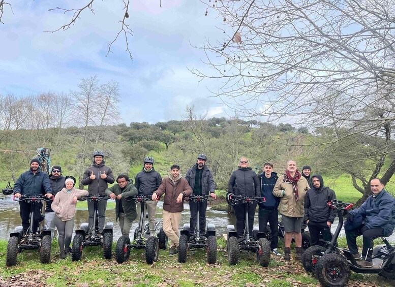 A group of people on electric scooters by a river. 3