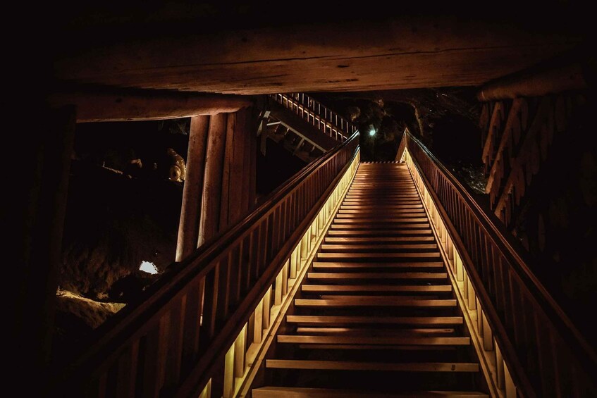 A wooden staircase leading downwards, surrounded by rock formations. 4