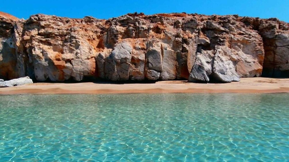A rocky coastline with clear turquoise water. 1