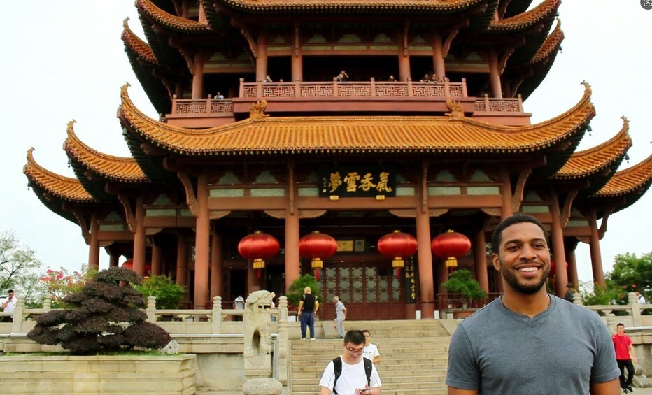 A traditional Chinese building with multiple tiers and ornate roofs, surrounded by stone steps and red lanterns. 2