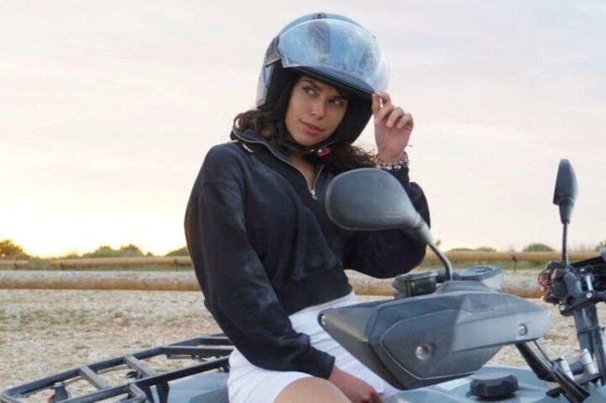 A person sitting on a motorcycle in a field with a clear sky. 4