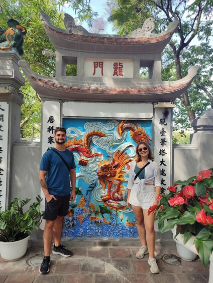A traditional Chinese gate with a dragon mural and Chinese characters. 1