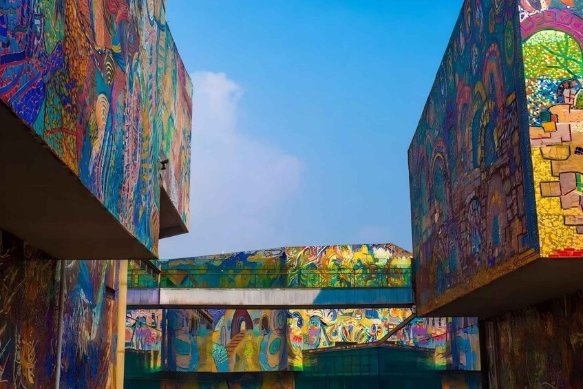 A colorful, graffiti-covered bridge with a clear blue sky above. 2