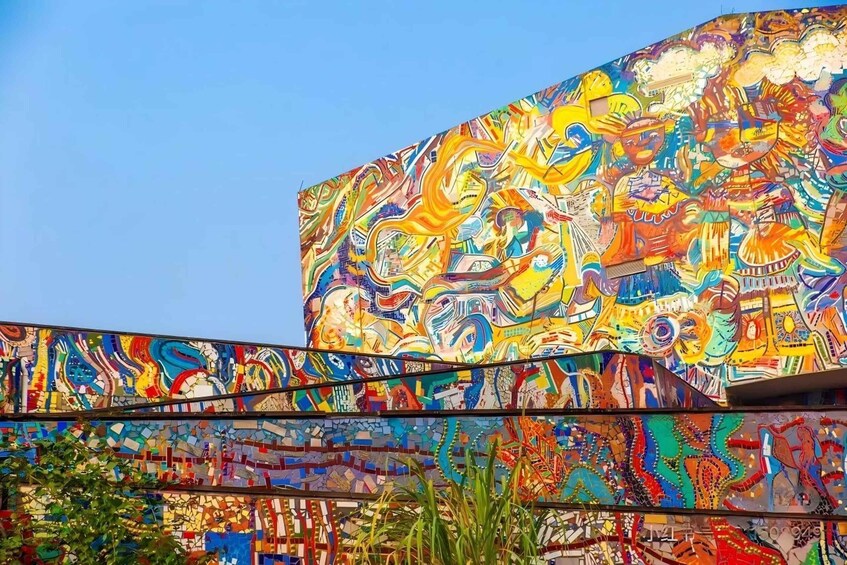 A colorful mural with abstract patterns and figures on a building. 5