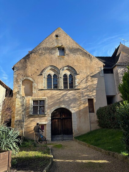 A historic building with arched windows and a wooden door. 2