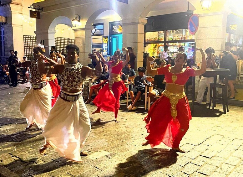 A street performance with dancers in traditional costumes. 1