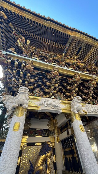 Ornate temple architecture with golden statues and intricate carvings. 1