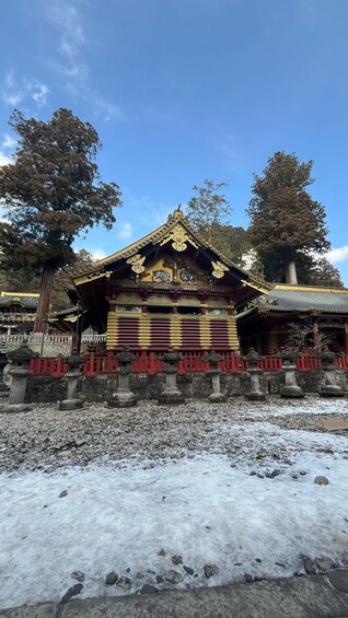 A traditional temple with ornate architecture, a stone pathway, and a snow-covered ground. 5