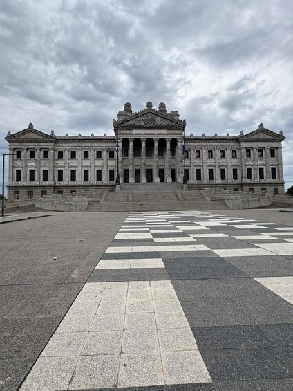 A grand neoclassical building with a symmetrical facade, large columns, and a central pediment. 4