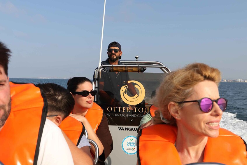 People on a boat with life jackets, a logo reading 'OTTER TOU,' and a 'Clean & Safe' certification. 5