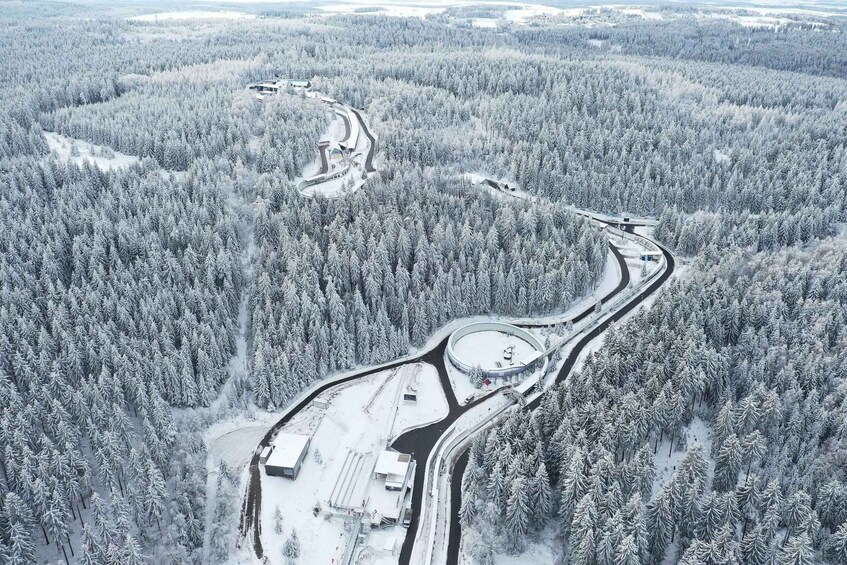 A snow-covered forest with a winding road and a roundabout. 3