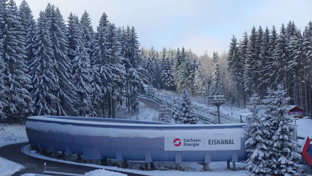 A snow-covered landscape with a sign for Sachsen Energie and EISKANAL. 2
