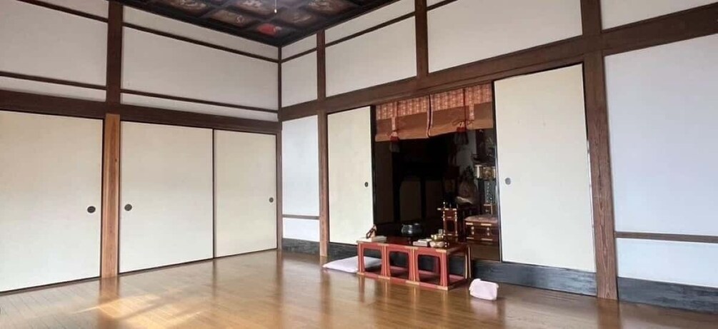 A traditional Japanese room with tatami flooring and shoji screens. 5