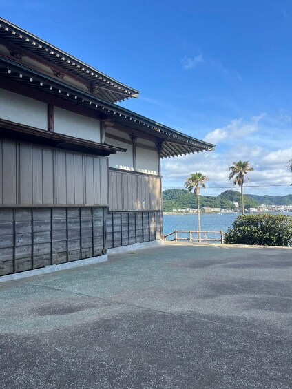 A traditional Japanese building with a view of a coastal landscape. 5