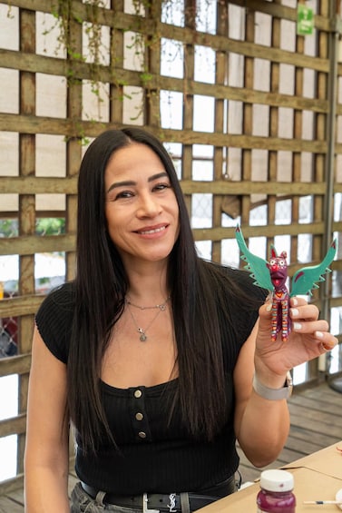 A person holding a colorful toy with wings. 2