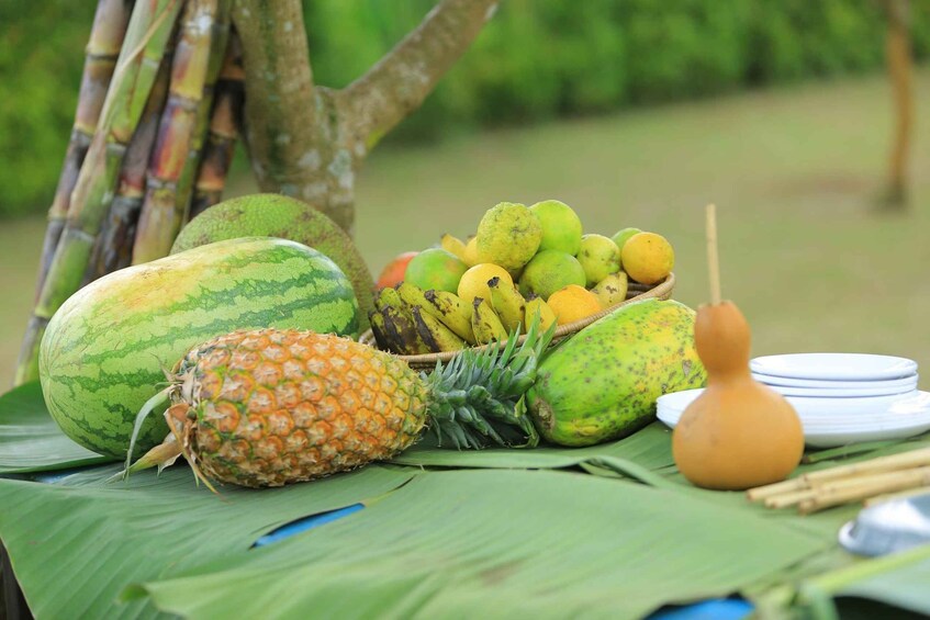 A variety of tropical fruits on a table outdoors. 3